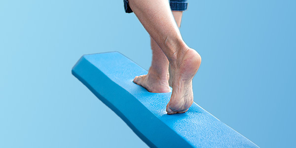 picture of a woman's feet in motion on a soft floor balance beam