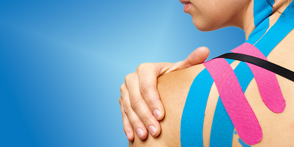 picture of young athletic woman's shoulder wrapped with kinesiotape