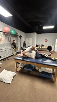 Demonstration of manual physical therapy for spinal mobilization.